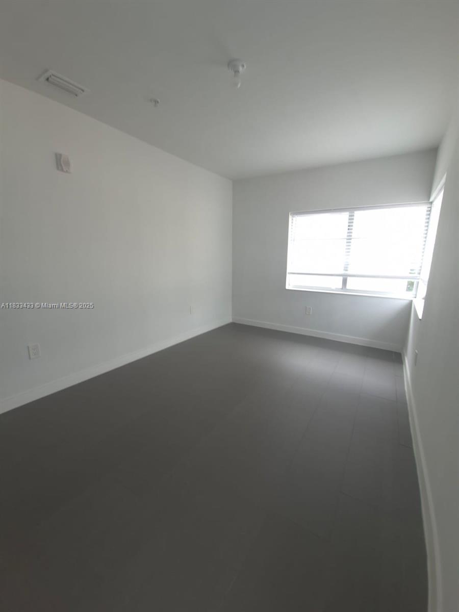 1211 Euclid Avenue, Unit 11 Miami Beach, FL 33139 - Photo 11 of 19 an empty room with a window