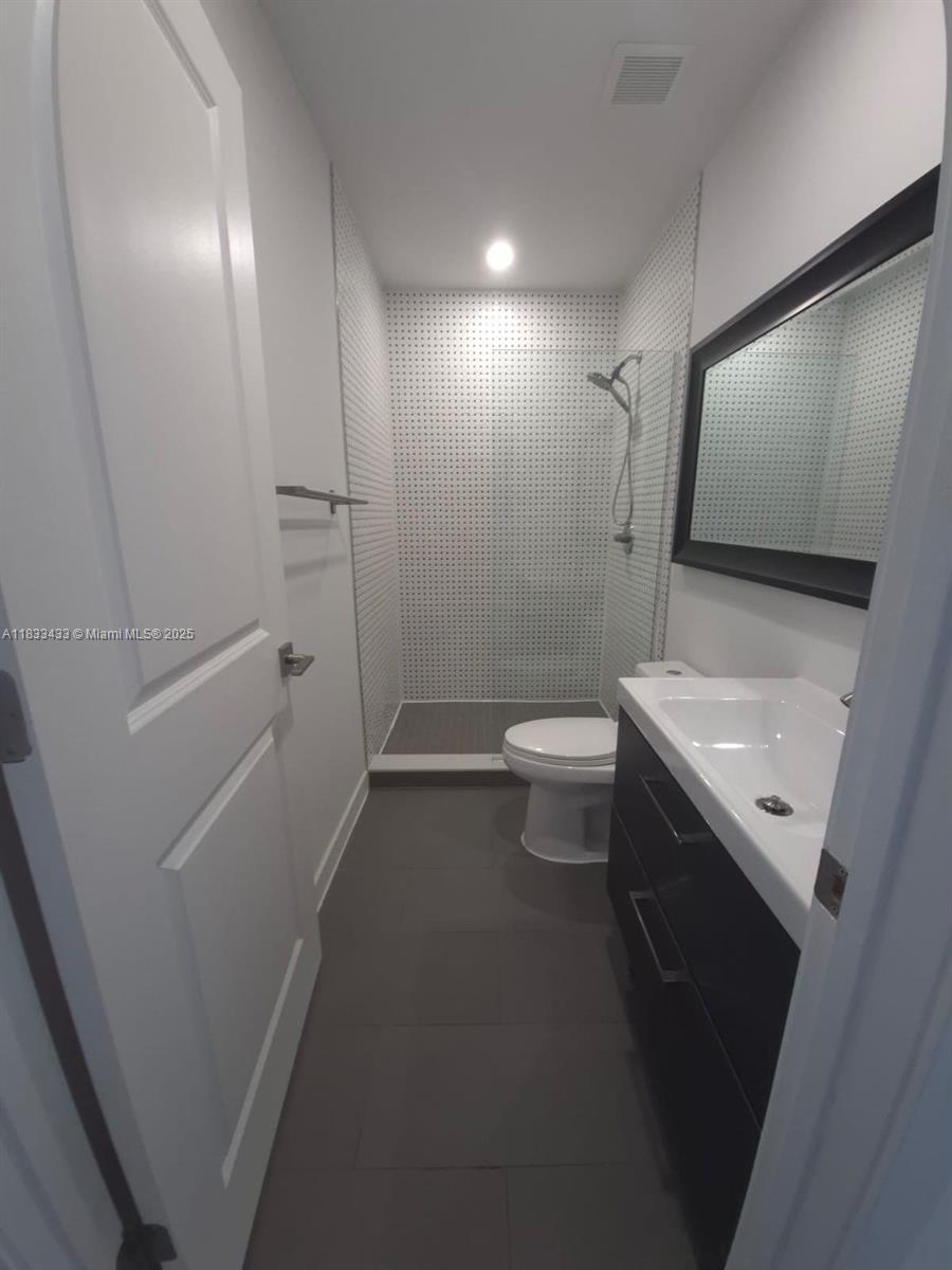 1211 Euclid Avenue, Unit 11 Miami Beach, FL 33139 - Photo 13 of 19 a bathroom with a sink a toilet and shower