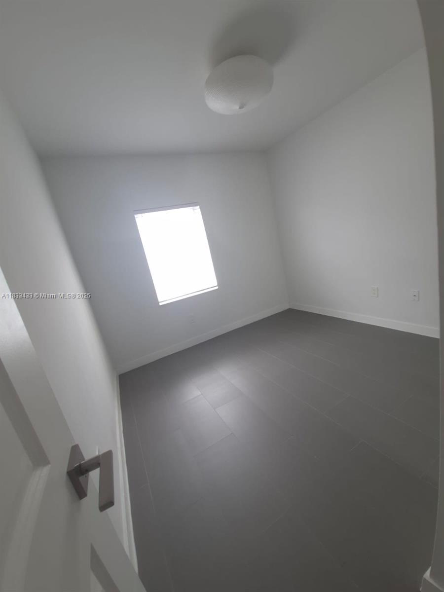 1211 Euclid Avenue, Unit 11 Miami Beach, FL 33139 - Photo 16 of 19 an empty room with a window