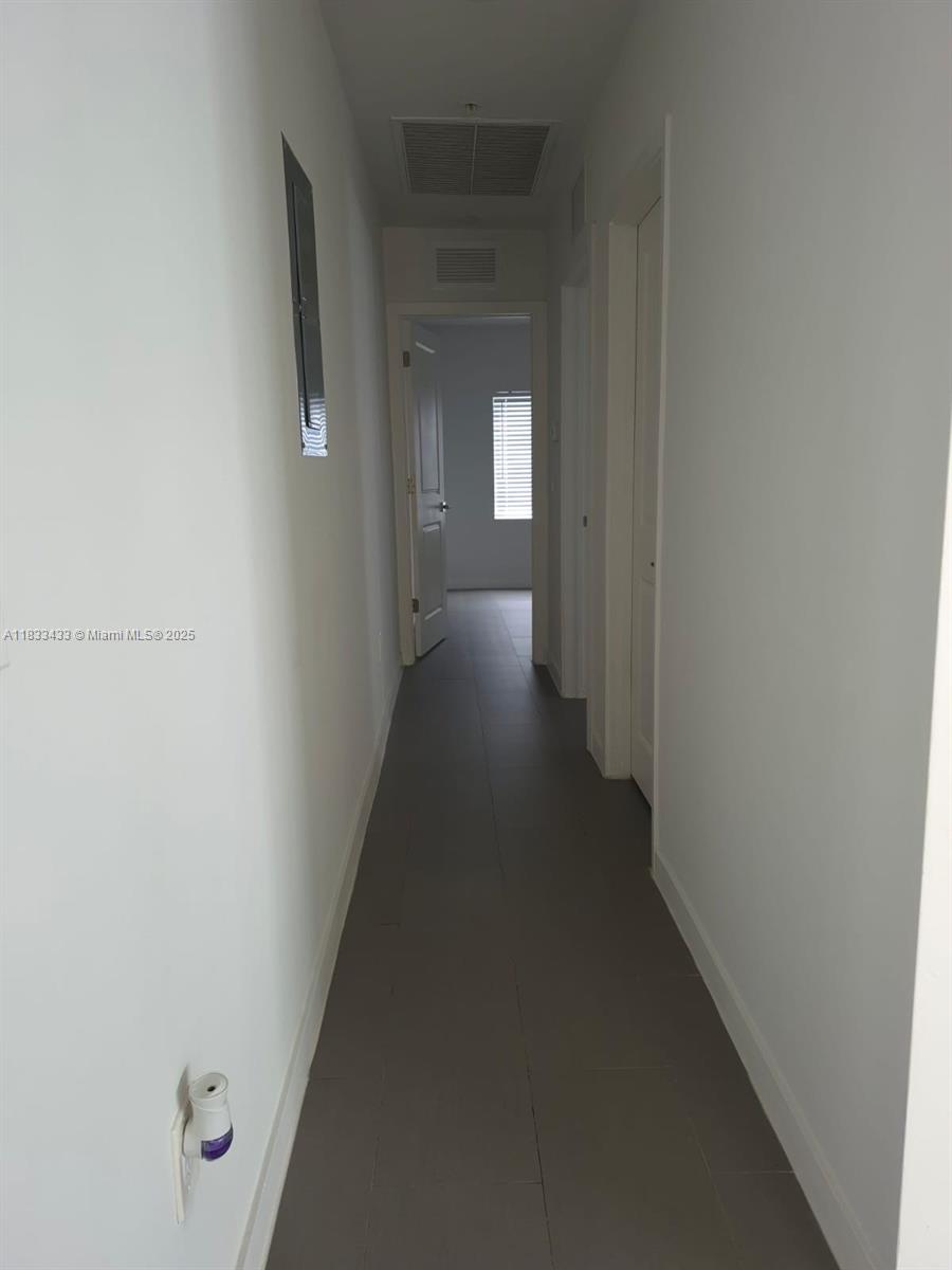 1211 Euclid Avenue, Unit 11 Miami Beach, FL 33139 - Photo 9 of 19 a view of a hallway with wooden floor and closet