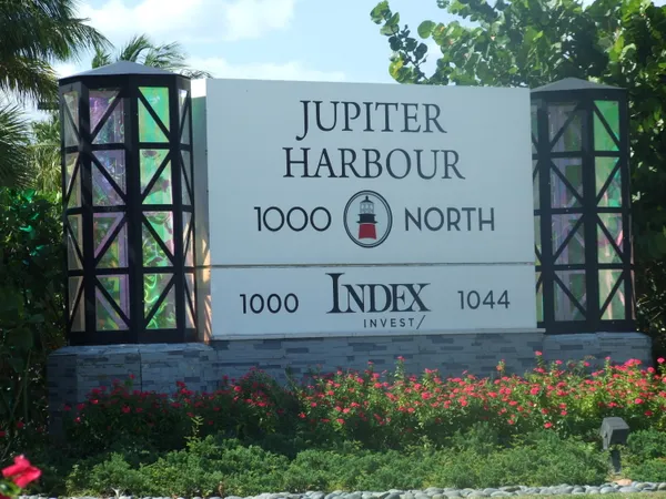 a sign broad in front of flowers