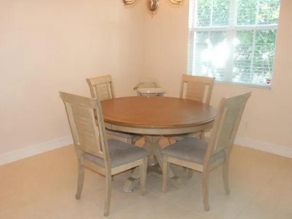 a dining room with furniture and window