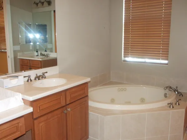 a white bath tub sitting next to a bathroom sink