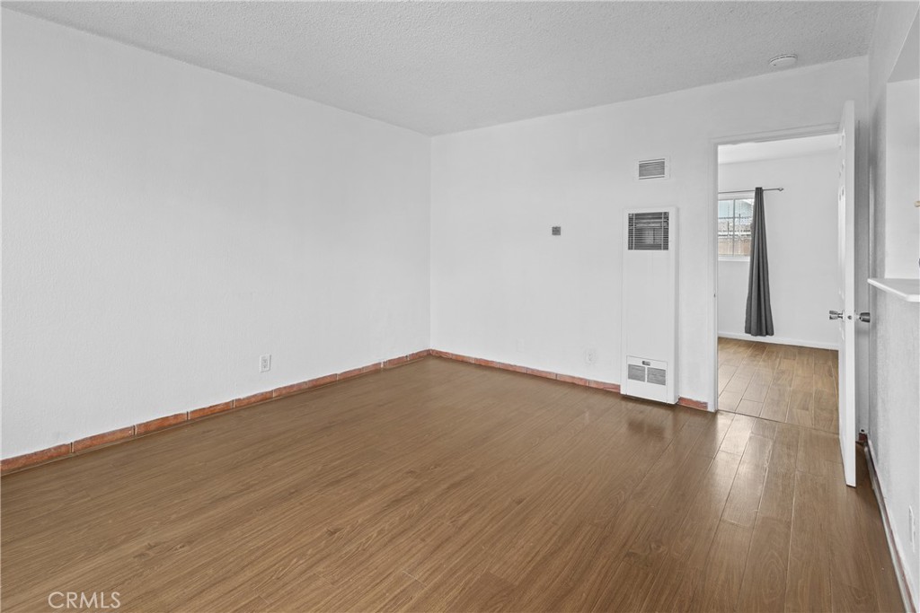 330 West Laurel Street, Unit A Compton, CA 90220 - Photo 7 of 10 a view of empty room with wooden floor