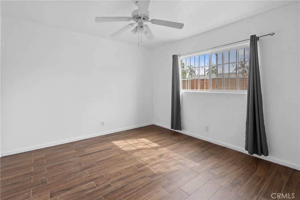 330 West Laurel Street, Unit A Compton, CA 90220 - Photo 8 of 10 wooden floor in an empty room with a window