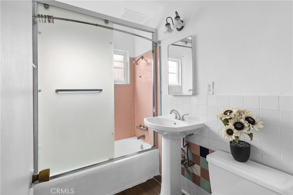 330 West Laurel Street, Unit A Compton, CA 90220 - Photo 10 of 10 a bathroom with a sink mirror and toilet