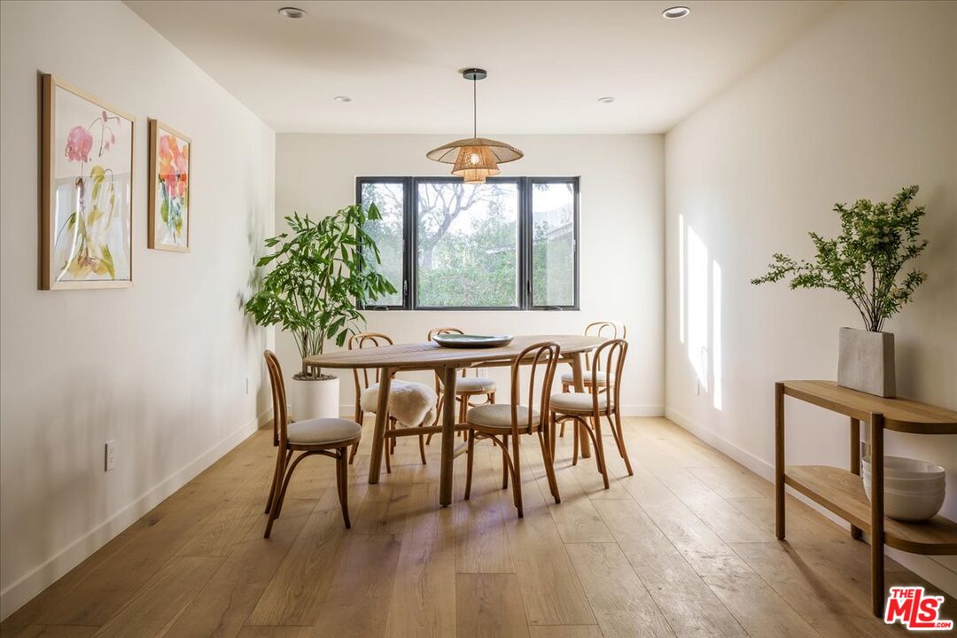 4119 Aralia Road Altadena, CA 91001 - Photo 13 of 37 a dining room with furniture potted plants and wooden floor