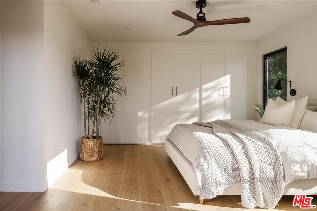 4119 Aralia Road Altadena, CA 91001 - Photo 16 of 37 a bedroom with a bed and a potted plant