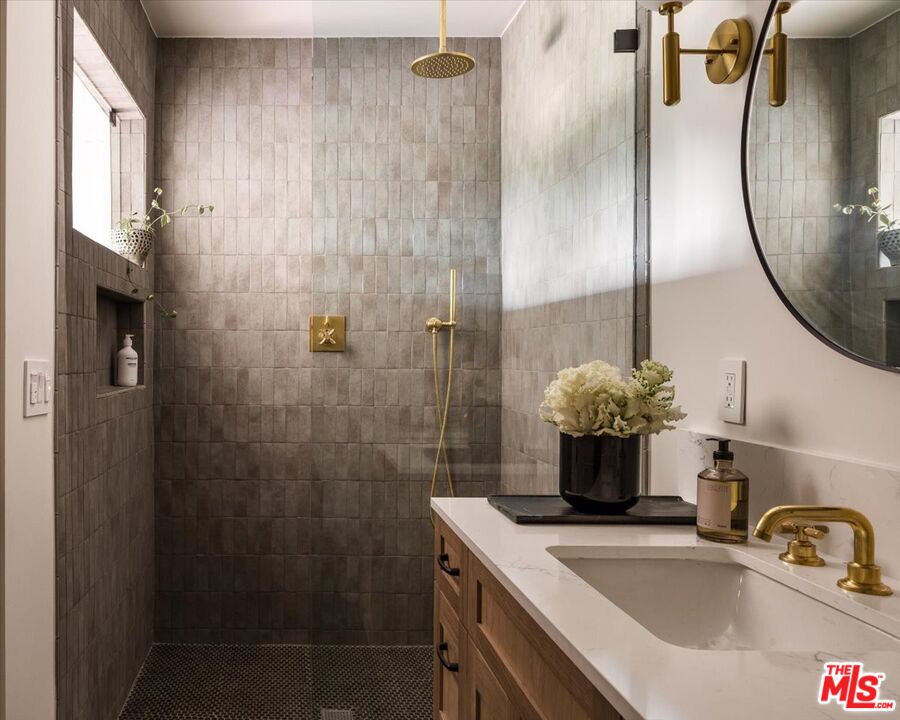 4119 Aralia Road Altadena, CA 91001 - Photo 22 of 37 a bathroom with a sink a mirror and a shower