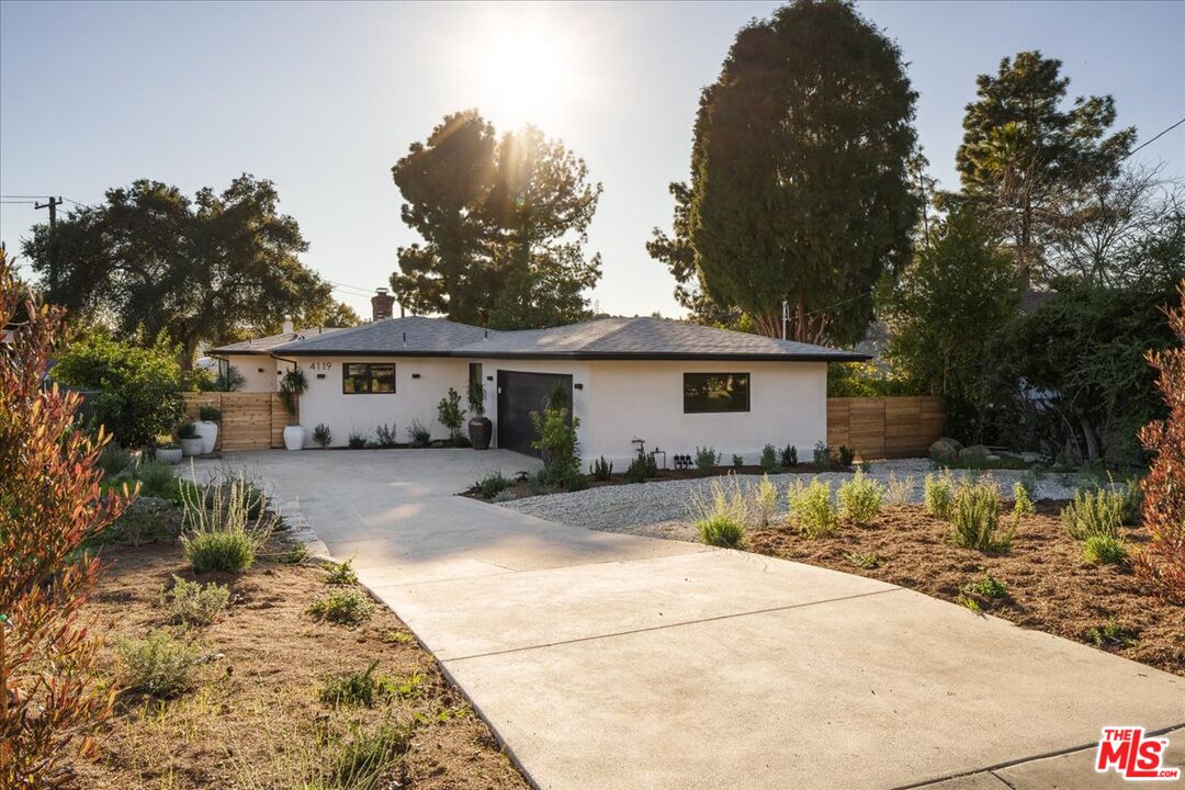 4119 Aralia Road Altadena, CA 91001 - Photo 29 of 37 a front view of a house with a yard and garage