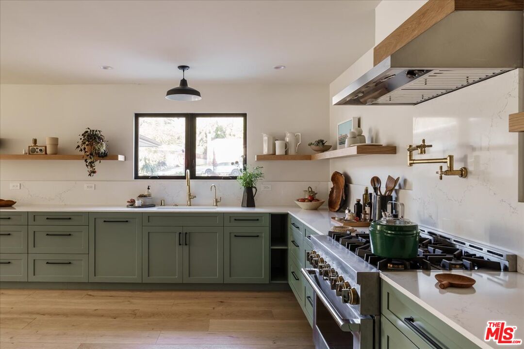 4119 Aralia Road Altadena, CA 91001 - Photo 5 of 37 a kitchen with a sink and cabinets