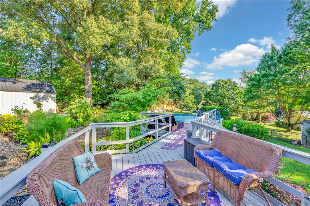 1305 Hanover Road Anderson, SC 29621 - Photo 20 of 29 A spacious wooden deck overlooks a lush private yard surrounded by mature trees.
