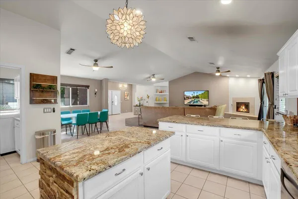 a kitchen with a stove center island and chairs