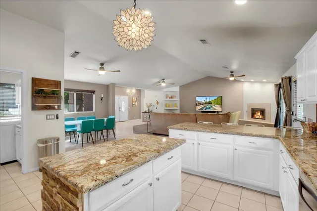 a kitchen with a stove center island and chairs