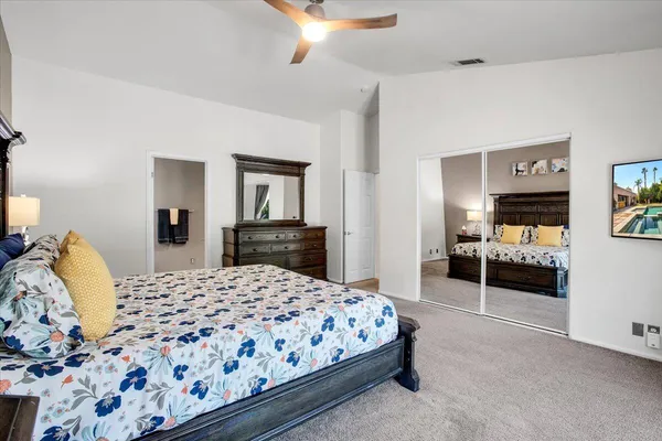 a bedroom with a bed and a couch