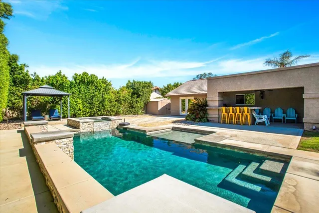 a view of a swimming pool with a patio