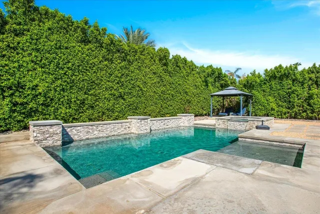 a view of house with swimming pool outdoor seating