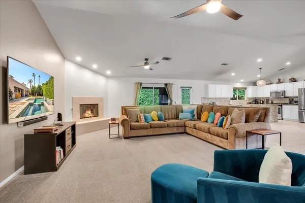 a living room with fireplace furniture and a flat screen tv