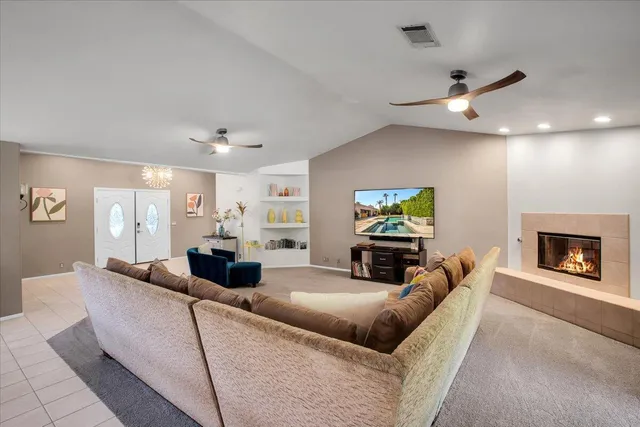 a living room with furniture and a fireplace