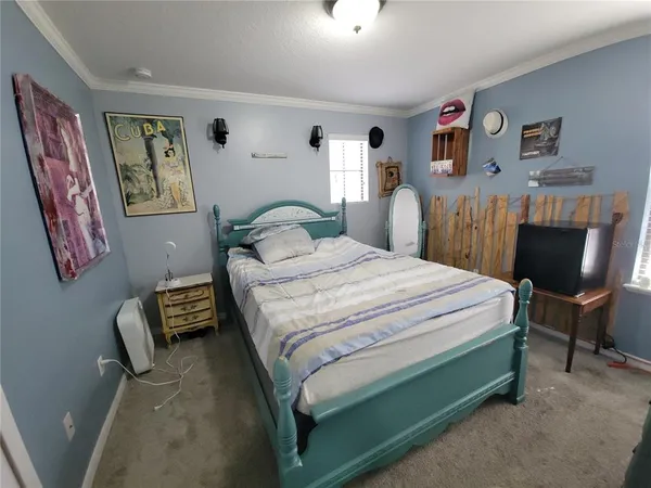 a bedroom with a bed and a chair