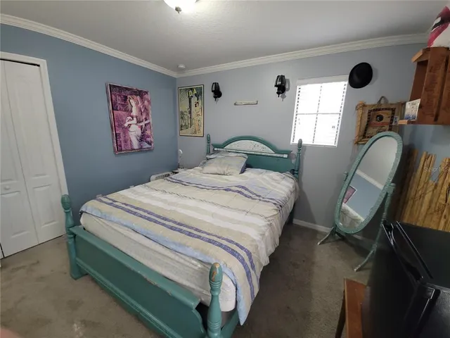 a bedroom with bed and window