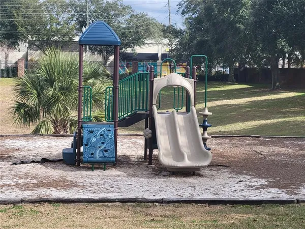 a front view of a house with swimming pool table and chairs