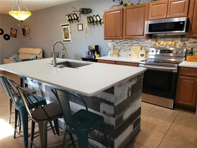 a kitchen with a stove a sink and a microwave