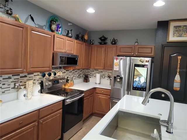 a kitchen with a sink cabinets and appliances
