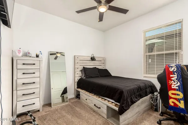 a bedroom with a bed and a window