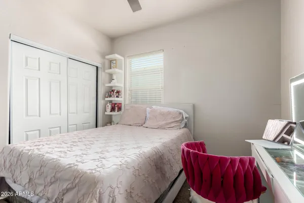 a bedroom with a bed and a chair
