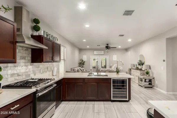 a kitchen with stainless steel appliances kitchen island granite countertop a sink and cabinets