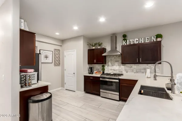 a kitchen with stainless steel appliances a sink a stove and a refrigerator