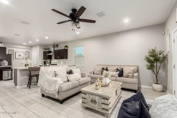 a living room with furniture and a potted plant