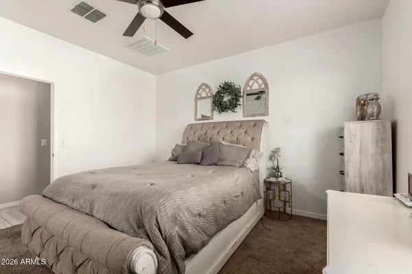 a bedroom with a bed and a dresser