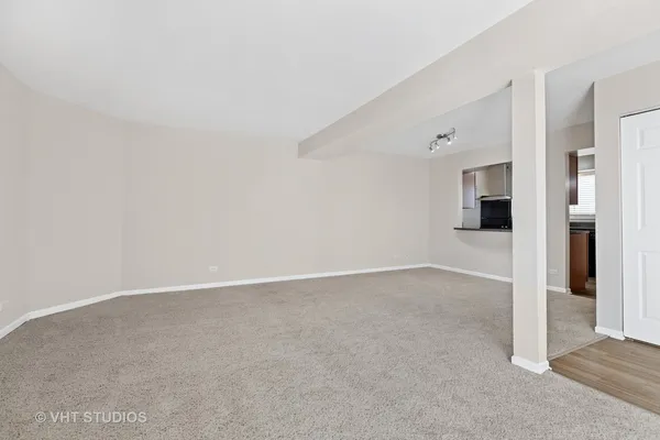 an empty room with an entrance to other room