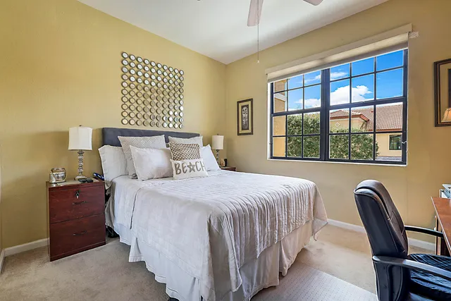 a bedroom with a bed chair and window