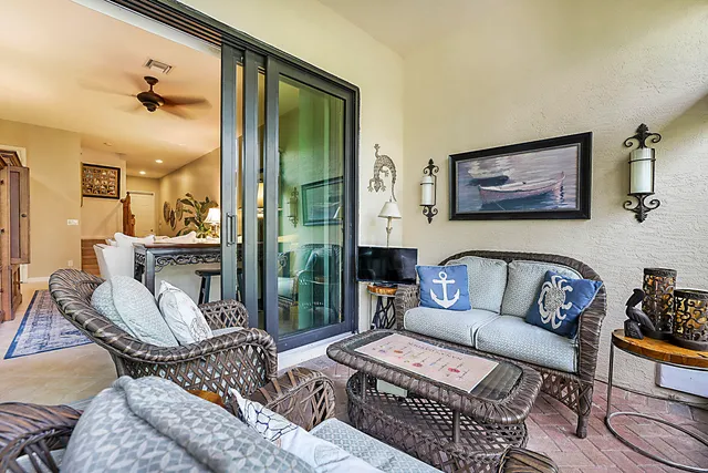 a living room with furniture and a floor to ceiling window