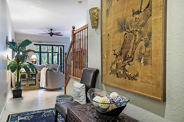 a living room with furniture and a potted plant