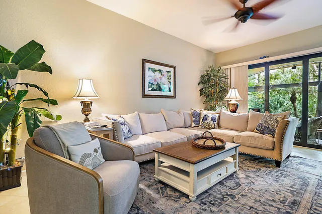 a living room with furniture a rug and a large window