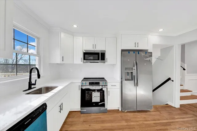 a kitchen with a refrigerator and a sink