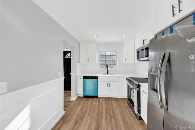a kitchen with stainless steel appliances a refrigerator and a stove top oven