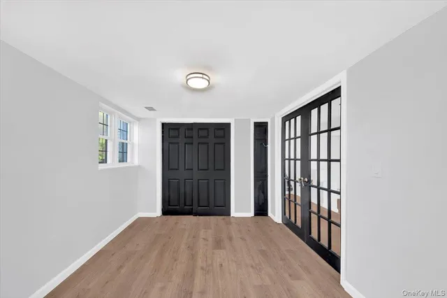 wooden floor in an empty room with a window