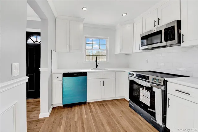a kitchen with a sink stove and microwave