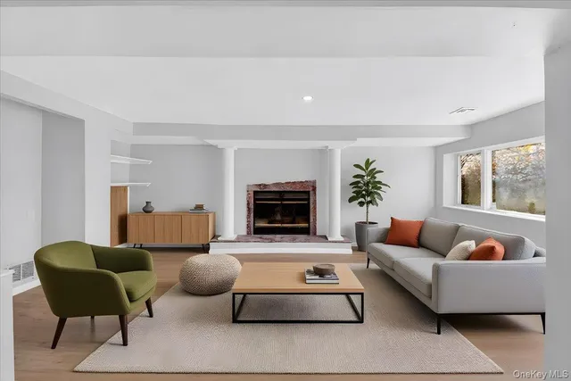a living room with furniture a flat screen tv and a fireplace