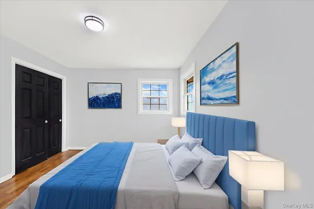 a bedroom with a bed and a painting on the wall