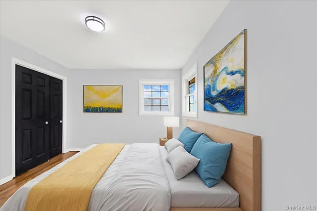 a bedroom with a bed and a painting on the wall