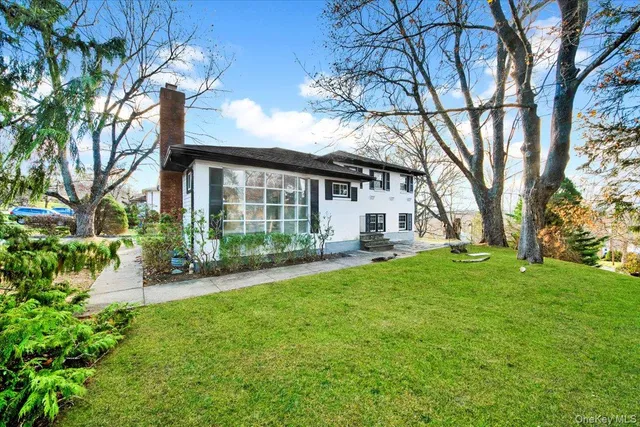 a front view of a house with a yard and porch