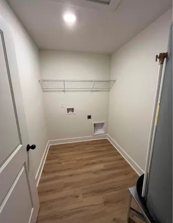 a view of a room with wooden floor