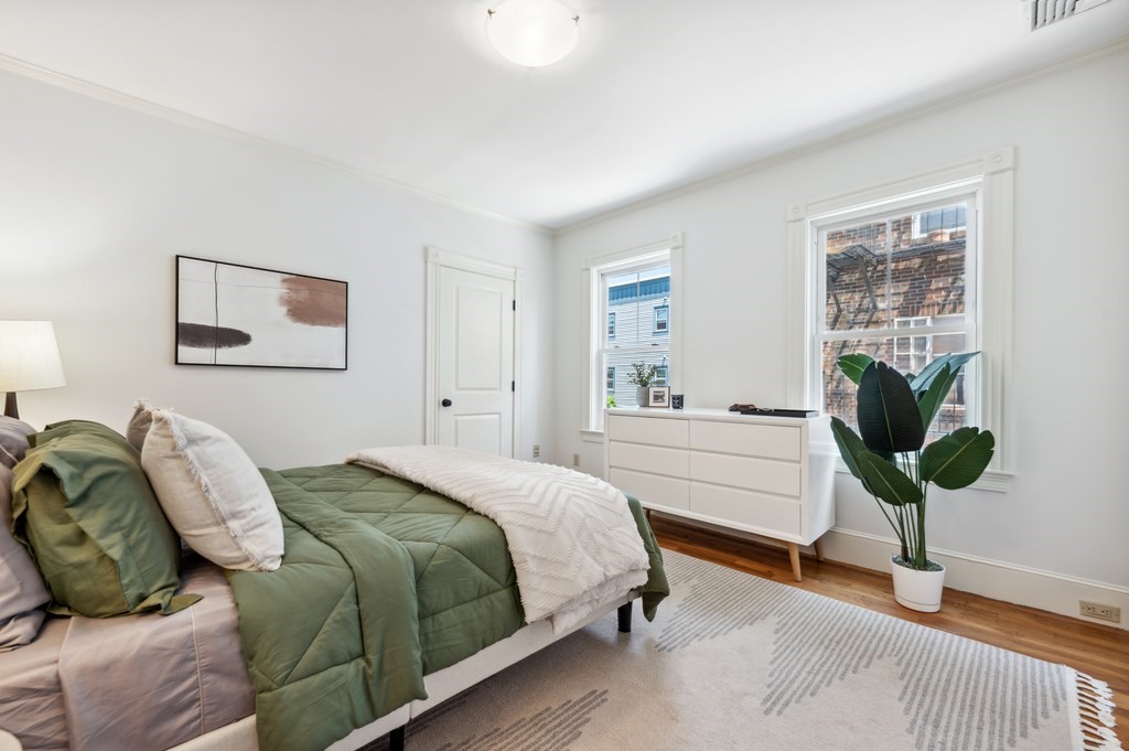 7 Haskell Street, Unit B Cambridge, MA 02140 - Photo 12 of 23 a bedroom with a bed and a potted plant
