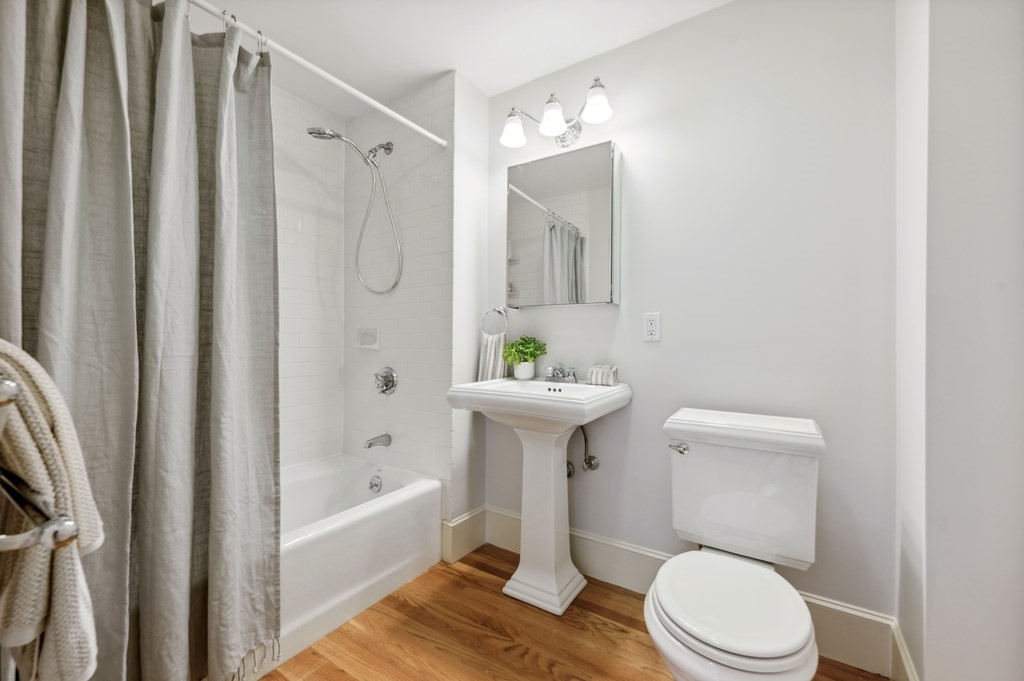 7 Haskell Street, Unit B Cambridge, MA 02140 - Photo 14 of 23 a white toilet sitting next to a bathroom sink